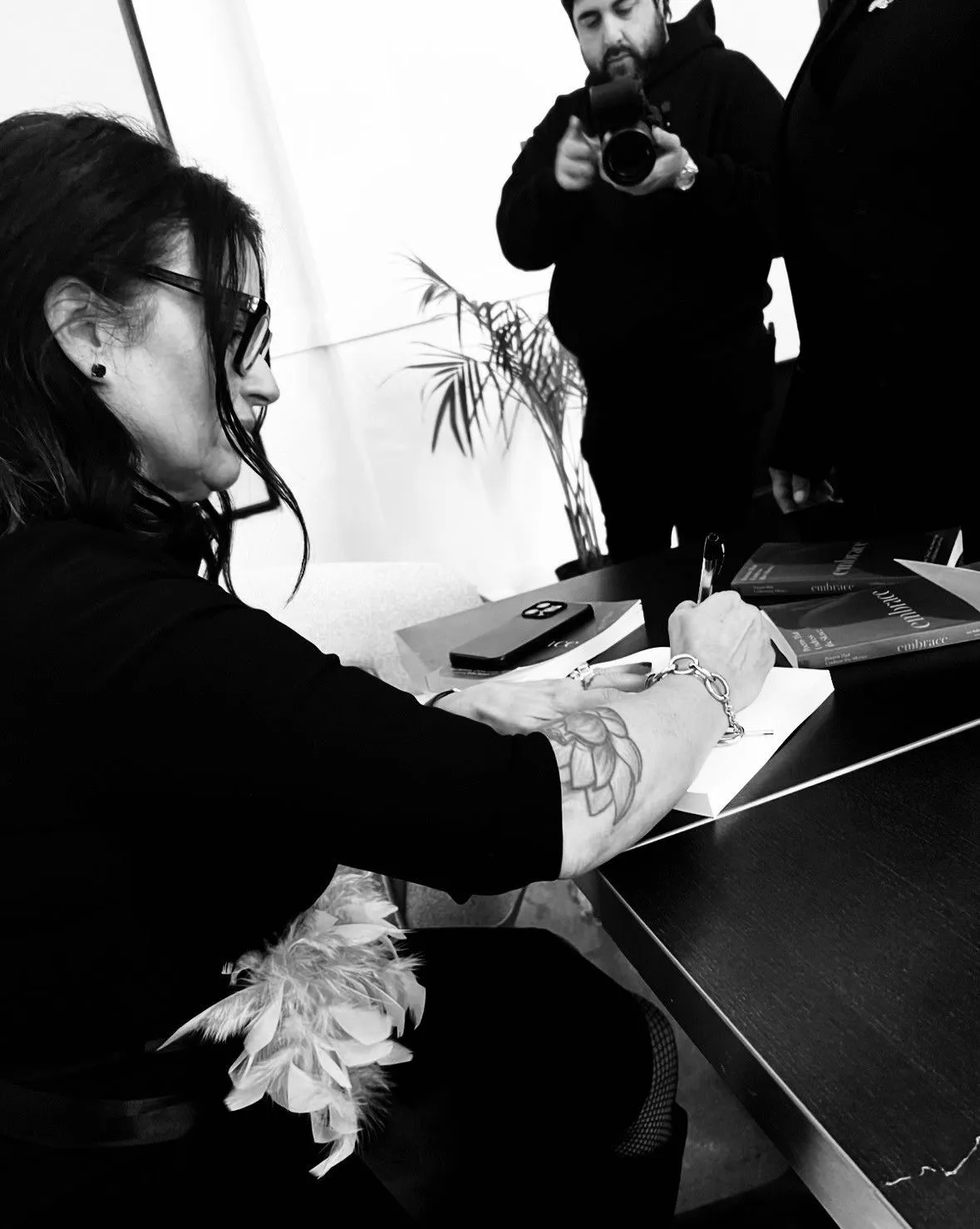 Lori Bellman signing a book at a book signing in LA